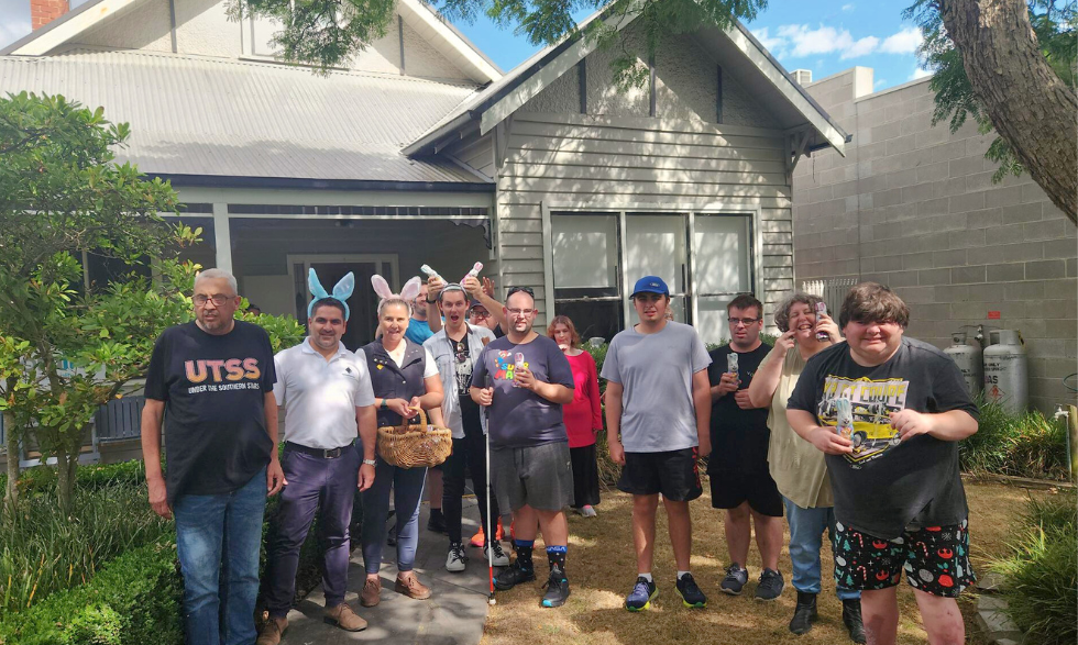 Image description: group of Yooralla clients and bank staff members, standing in front of their Community Hub.