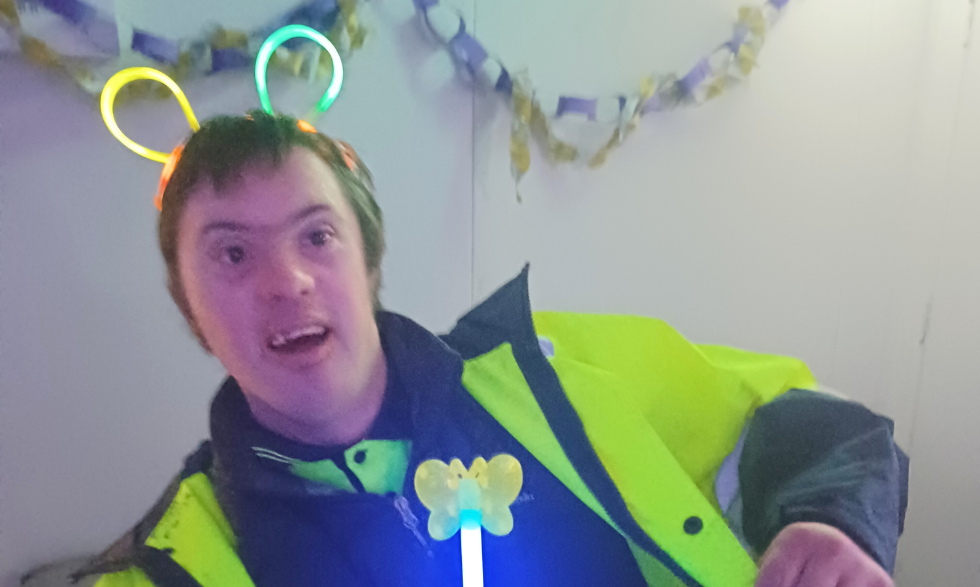 A client is wearing neon yellow with some glow-stick accessories and dancing