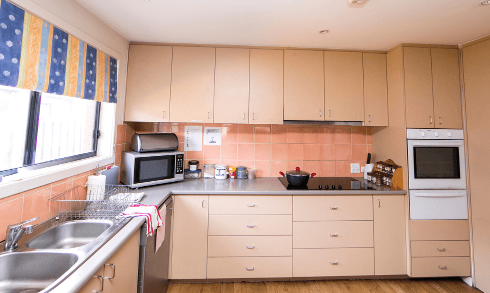 IMAGE: view of the property's kitchen area with microwave, plenty of storage, double sink and wide window