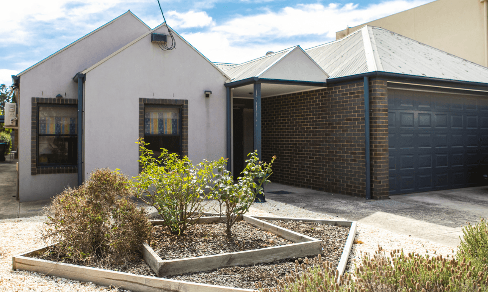 Front view of property from the street - neat garden with garage and wide front entrance