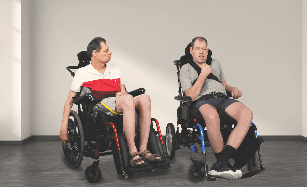 Image: Brothers Adam and Bradley sitting next to each other against a plain white background.